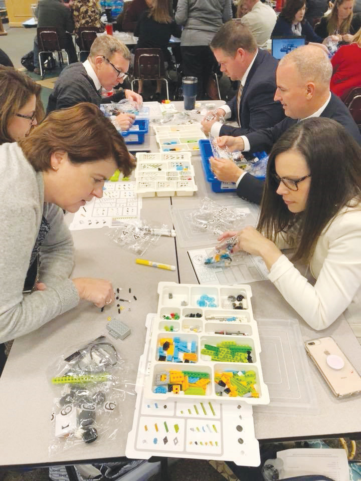 Clay County School Superintendent Addison Davis, second from right, digs right in with fellow administrators and leaders at the Nov. 27 STEM2Hub’s Robotics training day at the Fleming Island High Teacher Training Center.